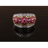 A 9ct gold ring set with three floret's of rubies,