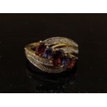 A gold garnet, diamond and amethyst dress ring, stamped 375. Size Q, 2.