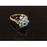 A 9ct gold cluster ring set with seven emeralds and six diamonds. Size M, 3.