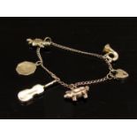 A 9ct gold charm bracelet six charms including padlock, witch on broom and violin 5.