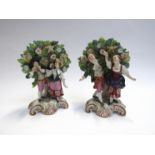 A pair of continental porcelain Bocage figural groups, dancers and musician, red crown mark to base,