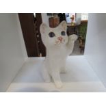 A Winstanley figure of a white kitten with raised paw and blue eyes,