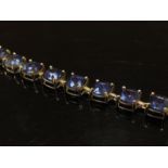 A 9ct gold bracelet set with 27 blue stones,