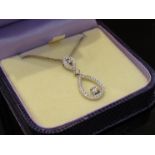 An 18ct white gold diamond set double drop pendant (2.