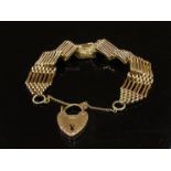 A 9ct gold seven bar gate bracelet with engraved padlock clasp, 23.