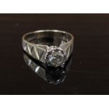 A solitaire diamond ring set in 18ct white gold with raised engraved shoulders. Size P, 4.