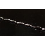 A white gold diamond bracelet stamped 9K, 18cm long, 2.