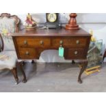 A mahogany two over two kneehole desk with satin and ebony crossbanding,