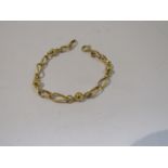 A gold engraved link and ball design bracelet, stamped 750, 19cm long, 8.