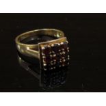A 9ct gold ring set with nine garnets in square setting. Size Q, 4.