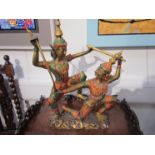 A 20th Century cast Thai sculpture depicting Yaksha with handpainted colourful embellishment 50cm x