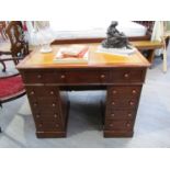 A mid Victorian mahogany twin pedestal desk the gilt tooled leather writing surface over eleven