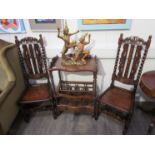 A pair of 17th Century revival oak upright hall chairs with carved coronet backrest and spiral