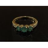 A 9ct gold emerald and diamond ring. Size O, 2.