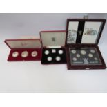 Three proof coin sets including Royal Mint 1984-1987 £1 silver proof collection.