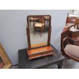 A 19th Century walnut toilet mirror with two base drawers over ogee bracket feet,