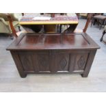 A circa 1700 panelled oak coffer with lidded internal candle box and carved lozenge decoration over