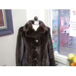 A 1950's/60's dark brown mink fur coat with stylised buttons