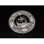 A large Celtic silver brooch with Viking long boat and mythological birds design.