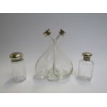 A twin vinegar/oil bottle and two silver topped dressing table bottles