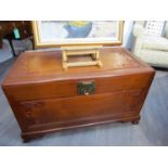 A camphor wood chest with Oriental decoration over ball in claw feet having internal sliding tray,