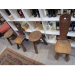 Four carved oak three legged stools with rabbit motif, maker's mark to the underside.