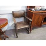 Two leather Jacobean style carver chairs,