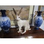 A Winstanley seated white hare, back leg repaired,
