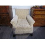 A late Victorian armchair with ball and claw feet,