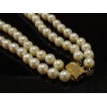 A double strand cultured pearl necklace with 14k gold clasp,