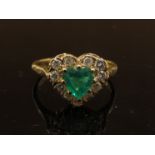 A 9ct gold ring set with central heart shaped emerald framed by diamonds. Size N, 2.