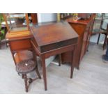 An early 18th Century oak desk on stand the rising slope and shelf interior over square tapering