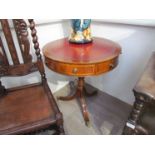 A George III revival mahogany revolving drum top occasional table the tooled leather insert over