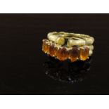 A 14ct gold ring with two "bamboo" effect bands set with five citrines. Size O, 8.