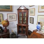 An Edwardian Art Nouveau influenced corner cabinet with brass inlay,