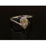 An 18ct white gold ring set with a yellow pear shaped diamond, 1.18ct. Size M, 2.