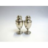 A pair of Victoria silver peppers with crested detail Charles Stuart Harris,