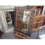 A carved oak rectangular hall mirror with acanthus and scroll detail,