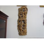 A carved African wall hanging, multiple figures,