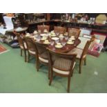 A 19th Century style dining table with eight matching chairs and extra leaf,