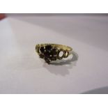 A 9ct gold garnet cluster ring. Size R/S, 2.