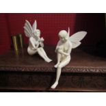 A pair of decorative fairy figures