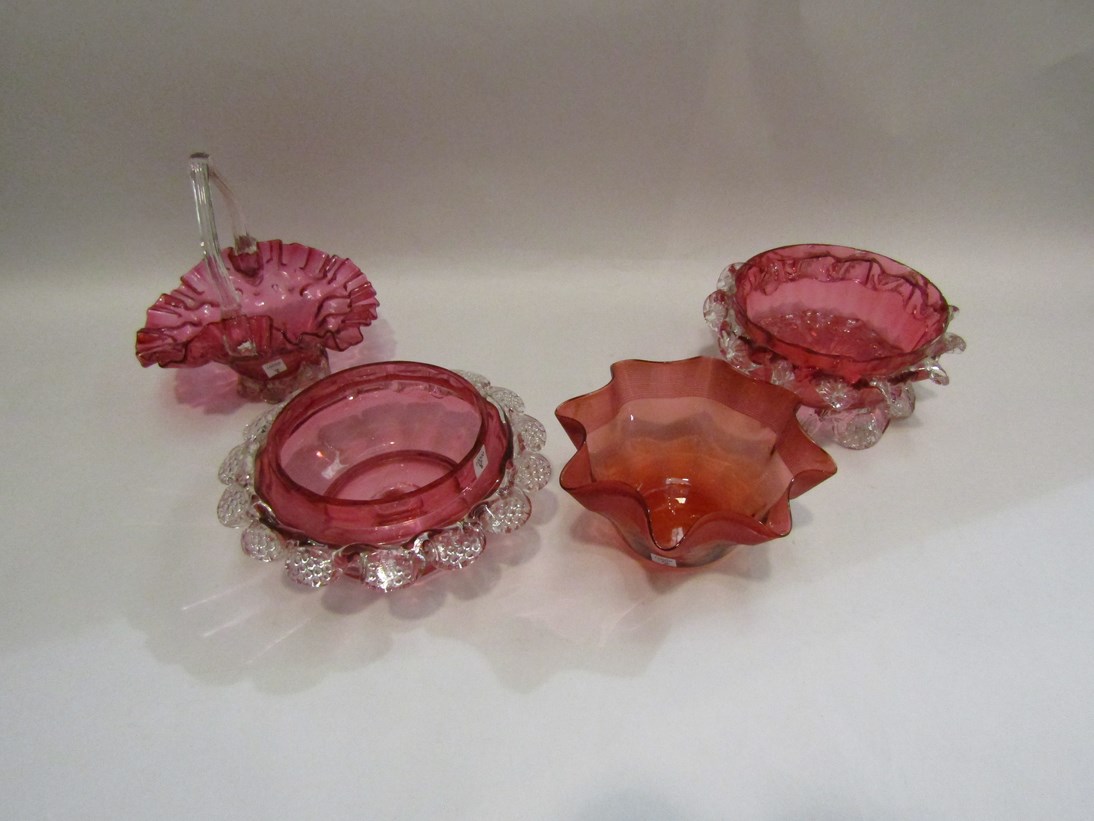 Four pieces of Victorian cranberry glass (three bowls and one basket)