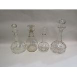 Four glass decanters with stoppers