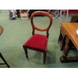 A set of six Victorian mahogany balloon back dining chairs on turned and tapering legs