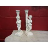 A pair of art form "Little Thinkers" candlesticks,