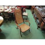 An early 20th Century beech framed bergere armchair