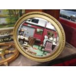 A gilt oval wall mirror,
