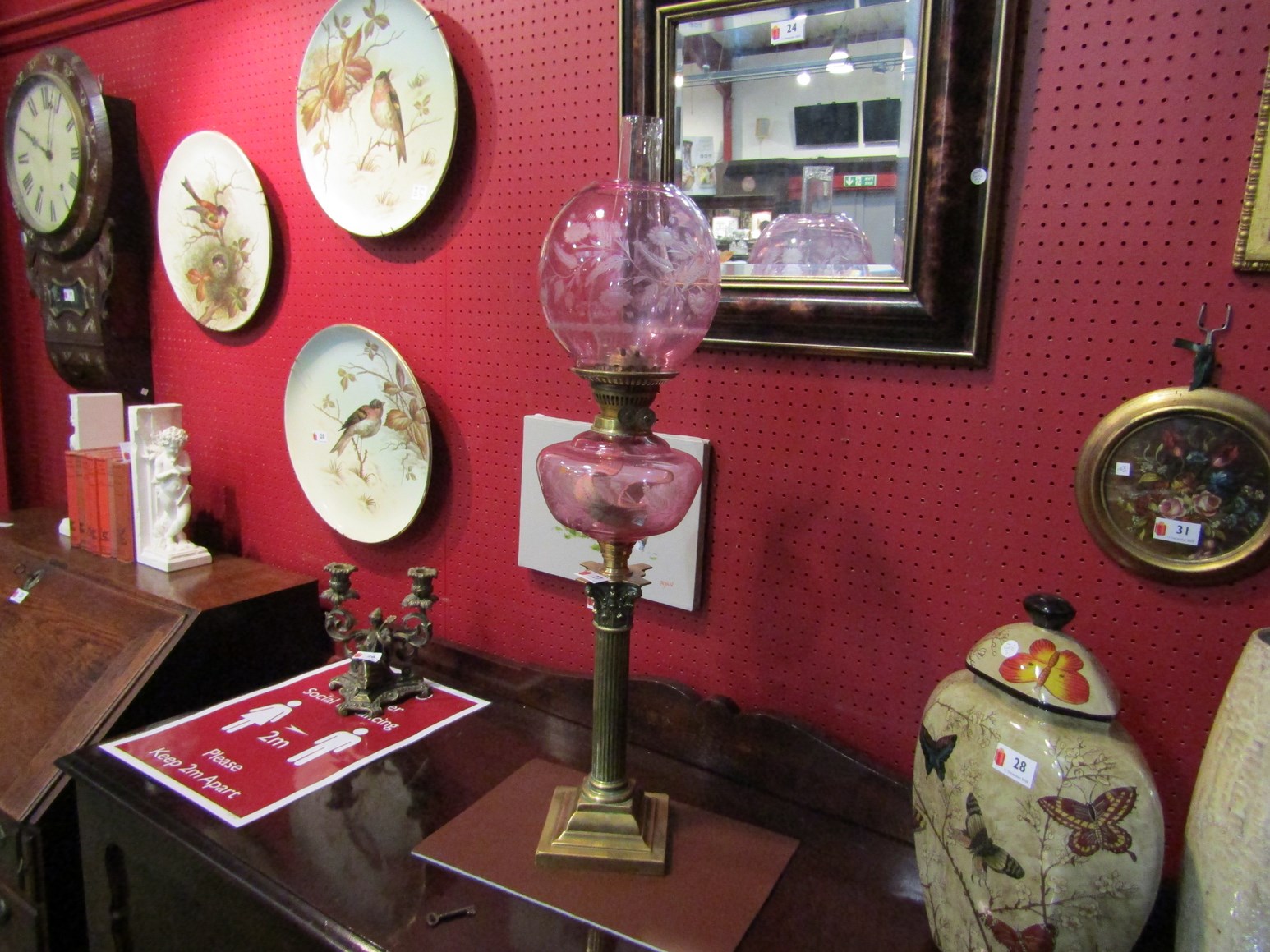 A Victorian oil lamp with pink reservoir and globular shade,