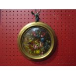 An oil on canvas of roses in cornflowers, gilt circular frame,